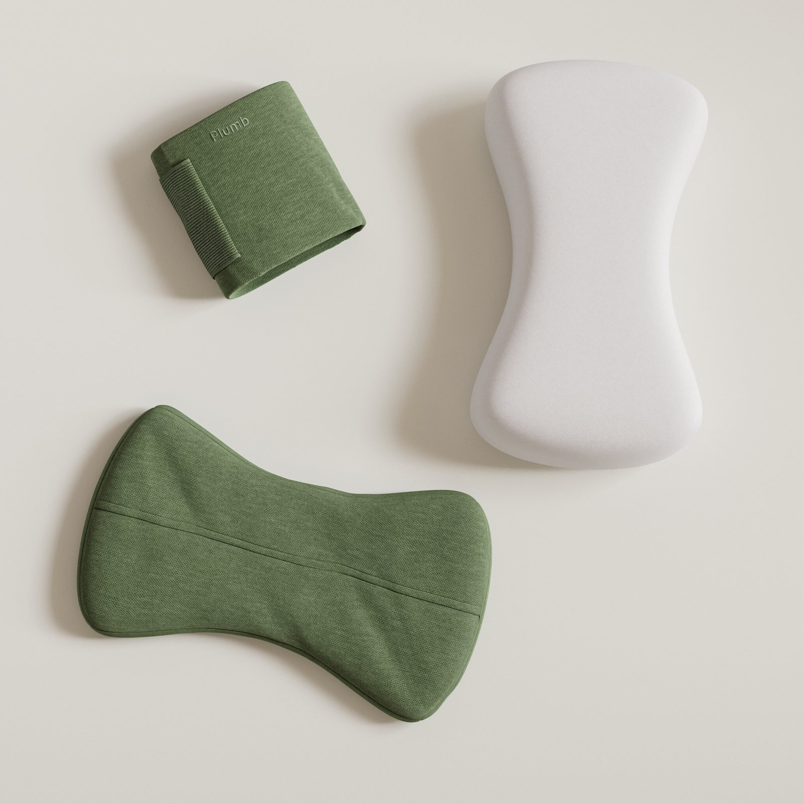 The three Plumb pieces laid flat: the green knit thigh sleeve, the bare foam pillow, and the foam pillow inside its washable pillowcase.